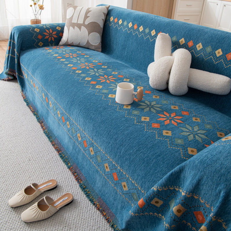 Housse réversible pour canapé bohème avec pompons – style chic et cosy