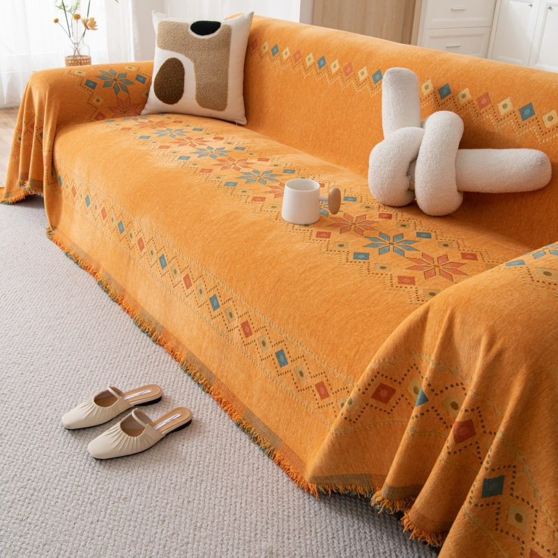 Housse réversible pour canapé bohème avec pompons – style chic et cosy