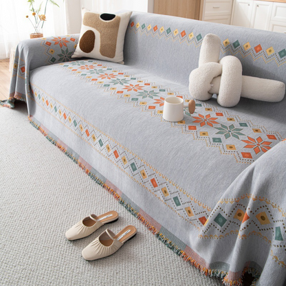 Housse réversible pour canapé bohème avec pompons – style chic et cosy